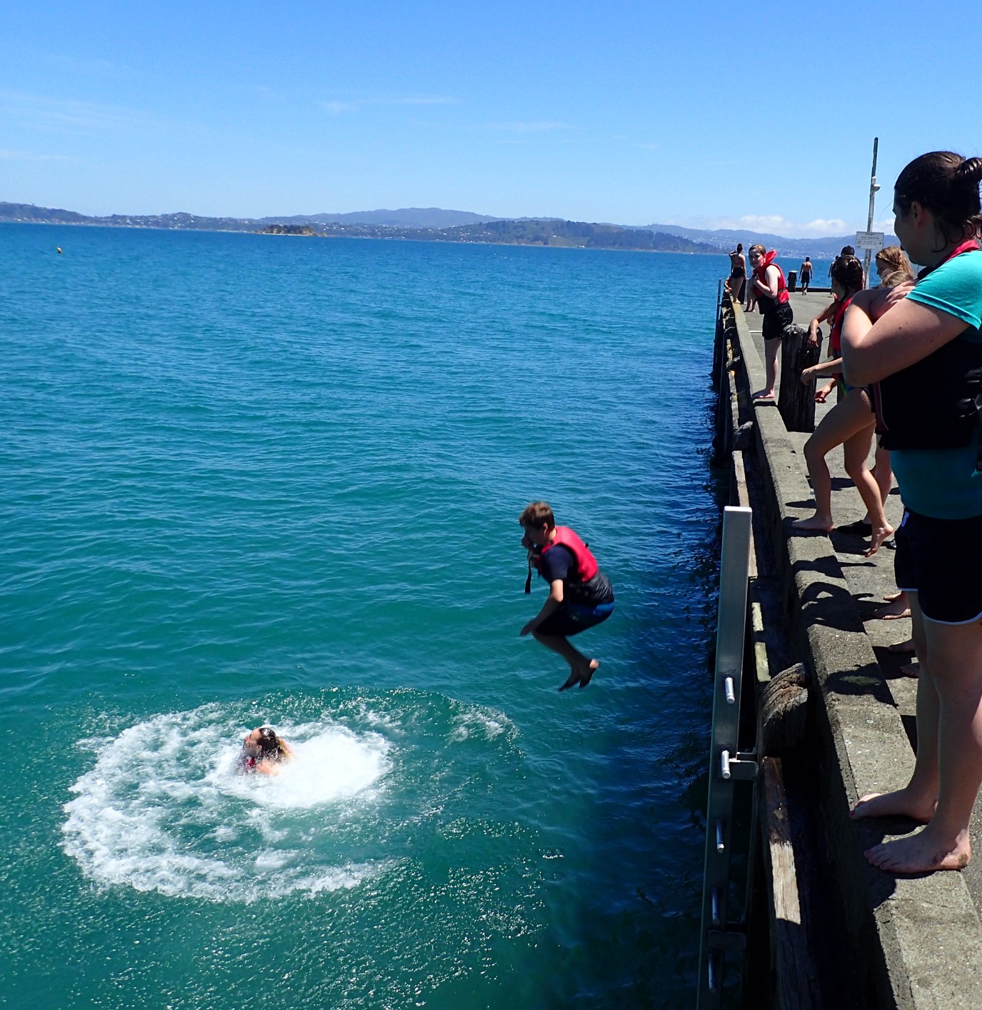 image of students jumping into water