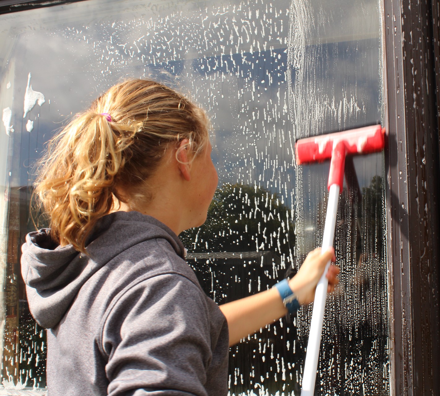 image of student wiping window